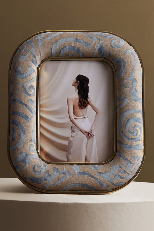 Decorative photo frame with a woman in a white dress on a brown background