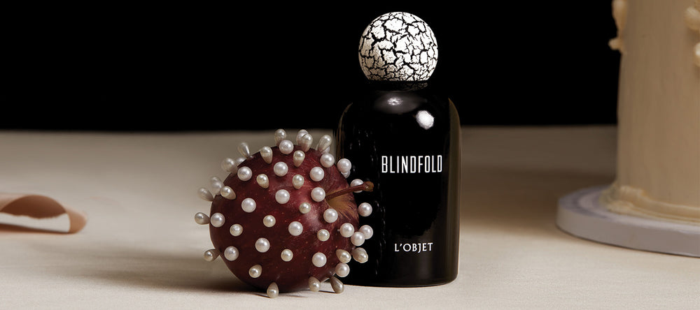 Black decorative object with textured surface and 'Blindfold' branding on a neutral background