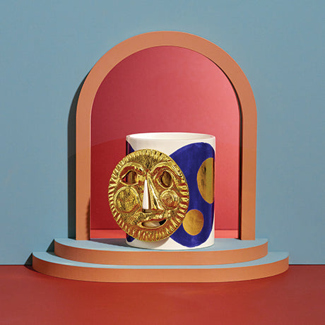 Ceramic mug with artistic design on a colorful geometric background