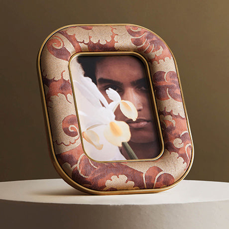 Decorative photo frame with a floral design on a neutral background